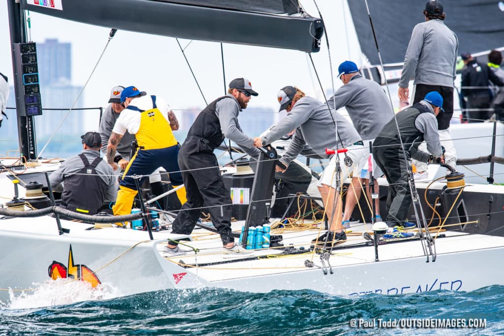 people racing sailboats