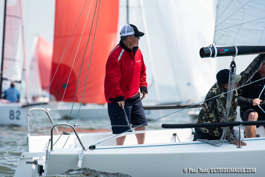 Man standing in a sailboat