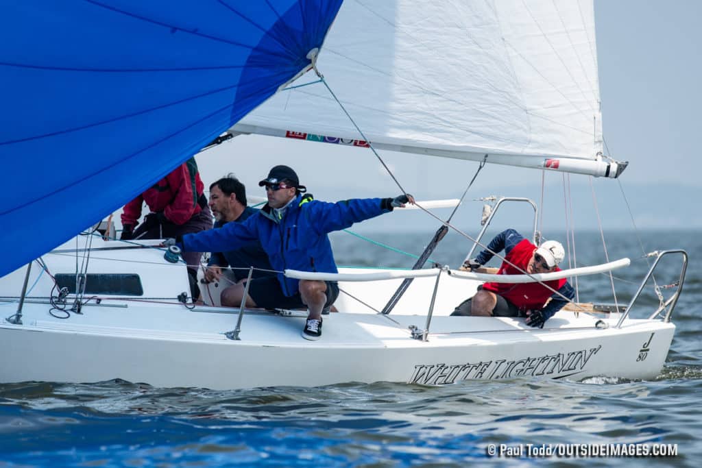 Men in a blue and white sailboat