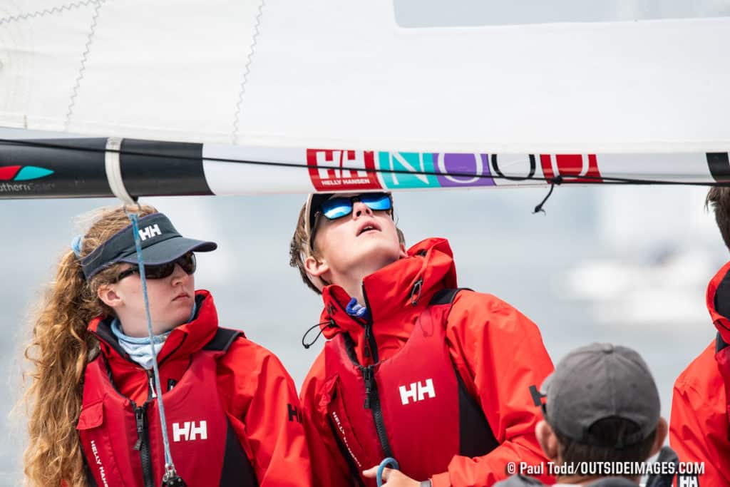 women in red jackets on a sailboat