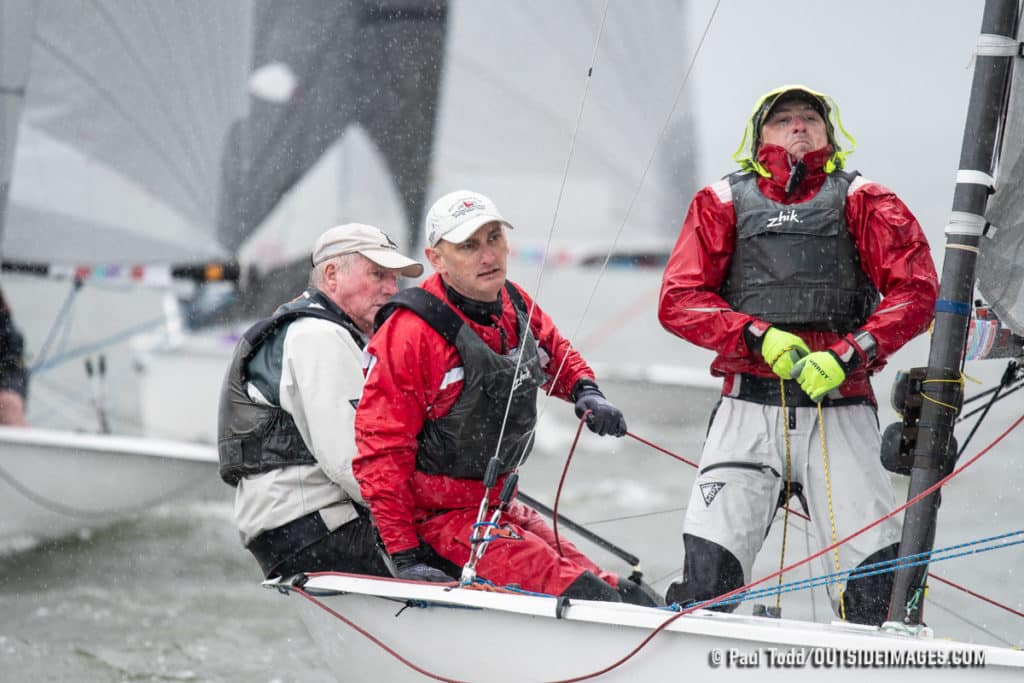 Man in red suit on a sailboat