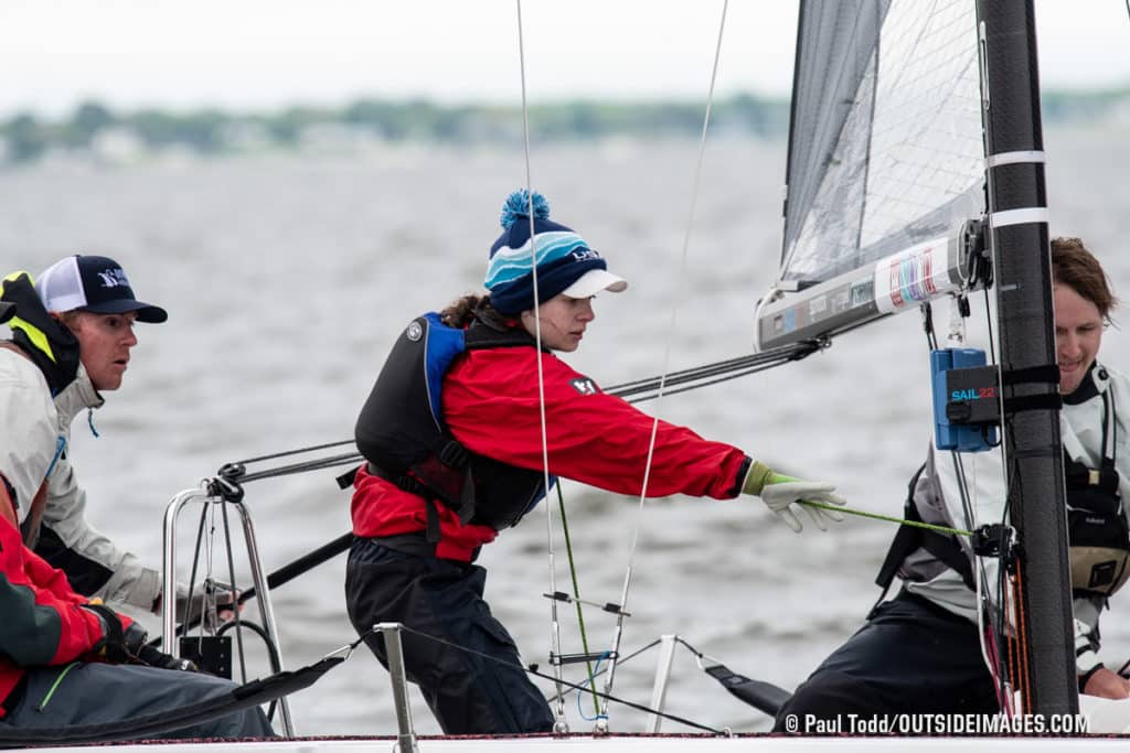 Man in red jacket on a sailboat