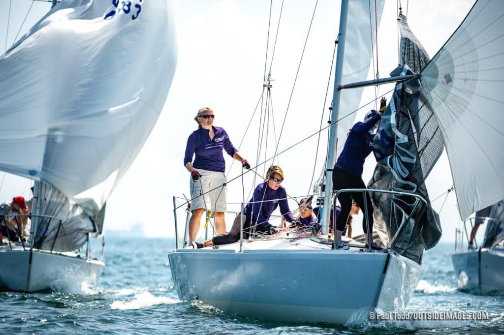 Emily Carville trims spinnaker aboard the J/24 Sea Bags Women’s Sailing Team