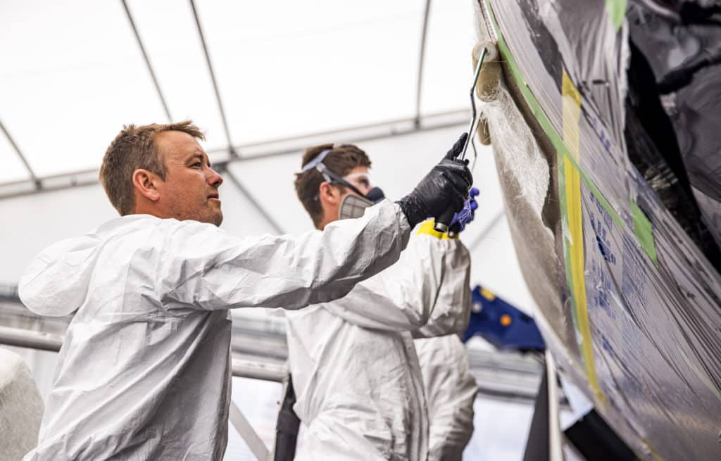 boatbuilders working on a boat hull repair