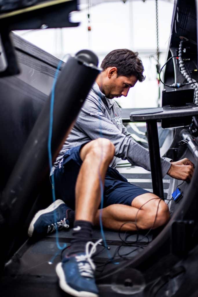 Man inside an AC75 installing electrical components