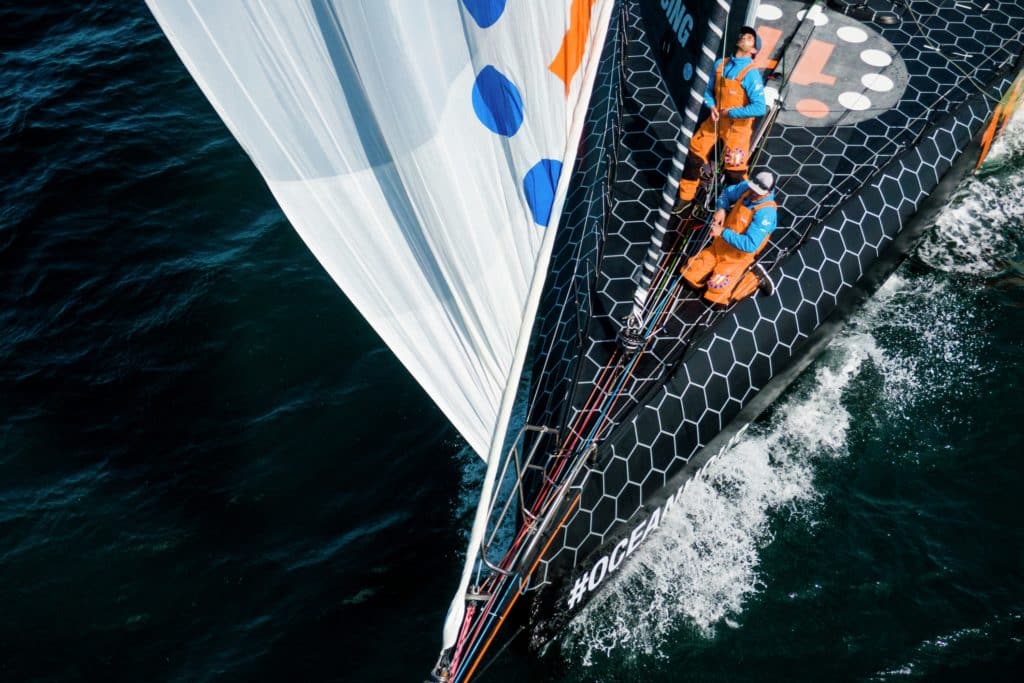 sailors on the foredeck of a raceboat handling the sails