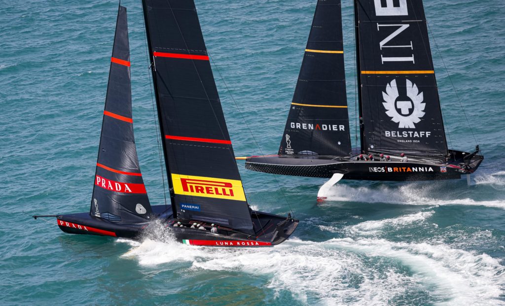 Two America's Cup 75s side by side racing in Auckland as seen from a helicopter