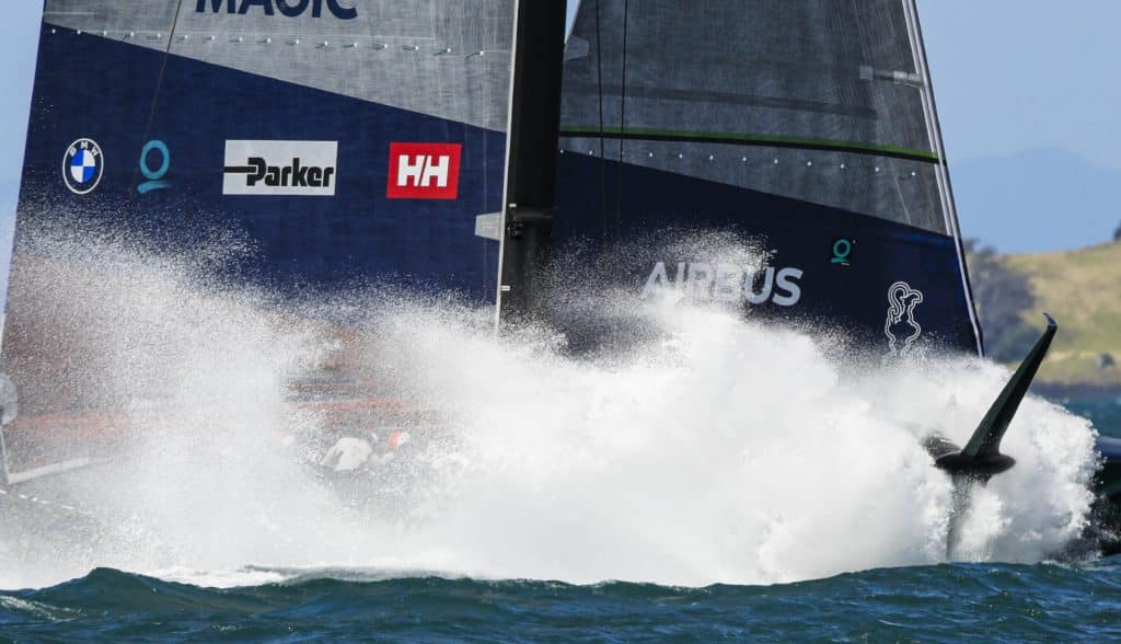 An AC75 crashing into the water in a ball of spray.