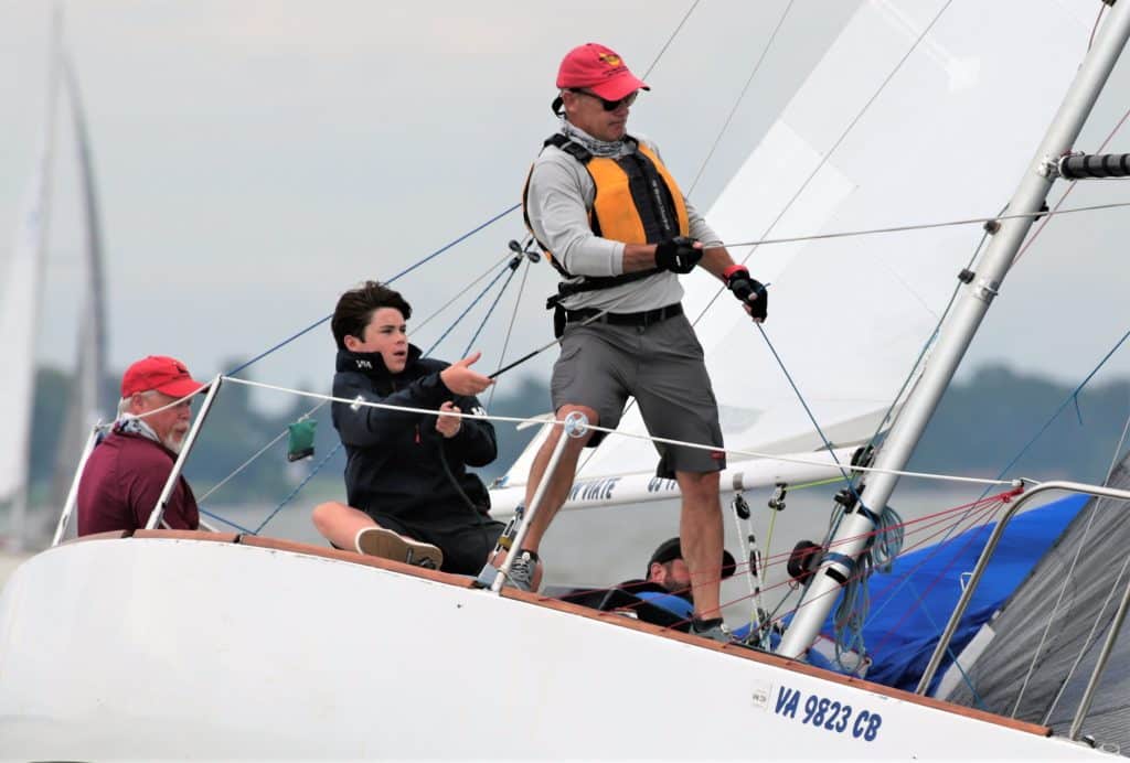 Sailboats racing on the Chesapeake Bay and Annapolis, Maryland with crews and spinnakers and fleets of sailboats.