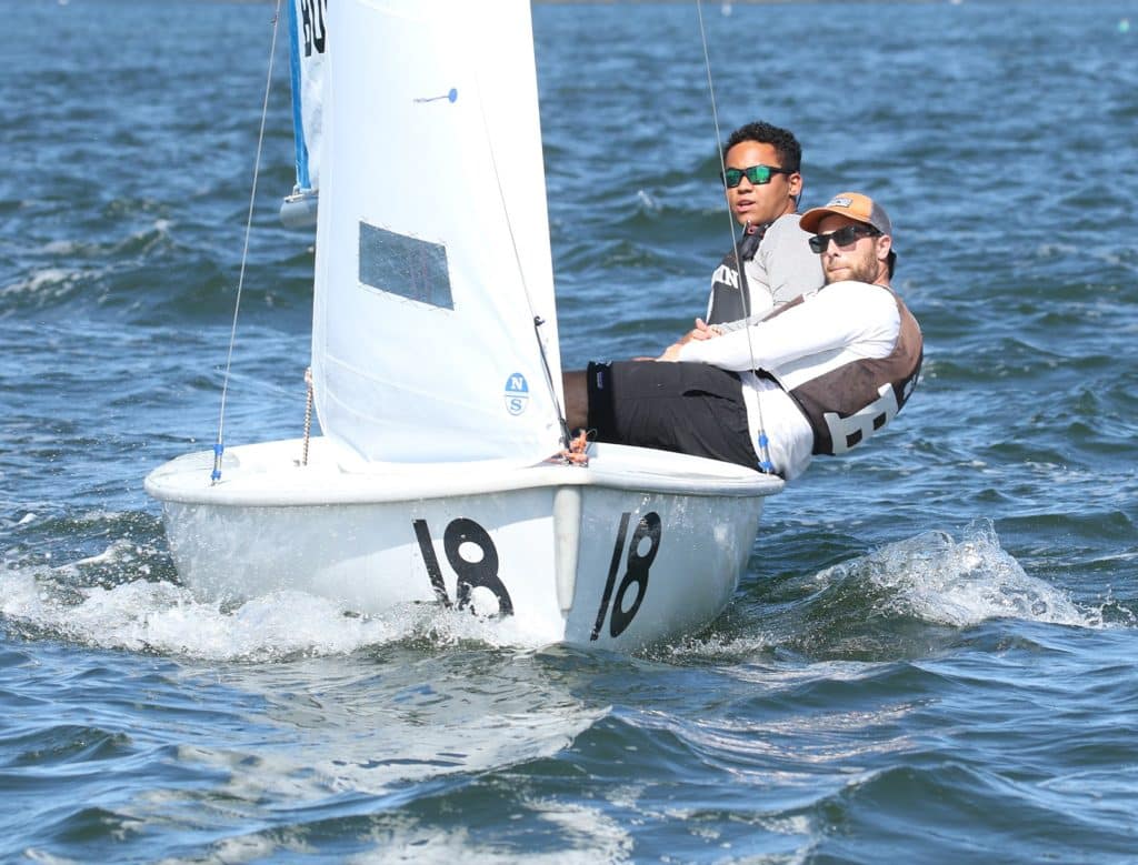 college sailors in a small dinghy