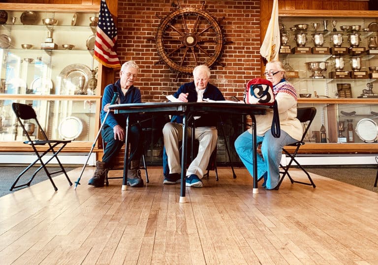 Dr. Charles Shoemaker, Dr. Robin Wallace, and Nancy Parillo convene at Newport YC for the Frostbite season's first hearing.