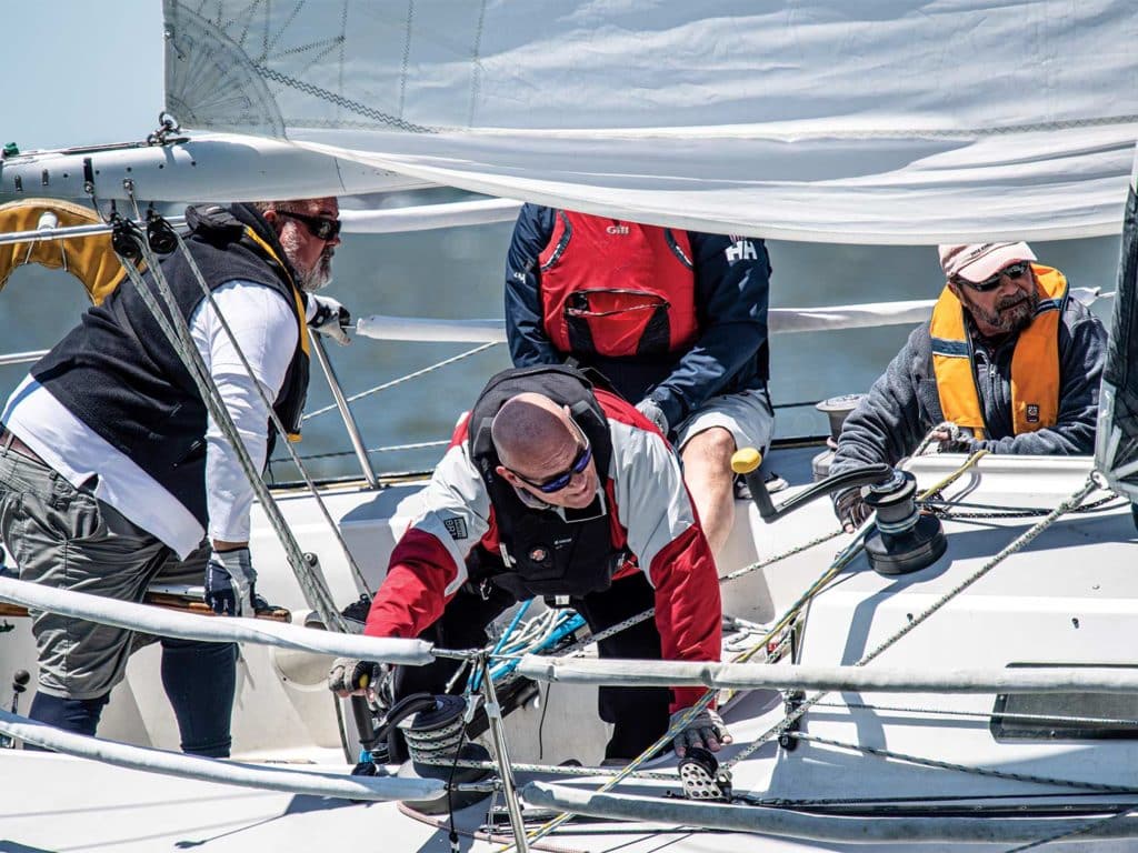 A crew working aboard a sailboat at the Annapolis NOOD Regattas.