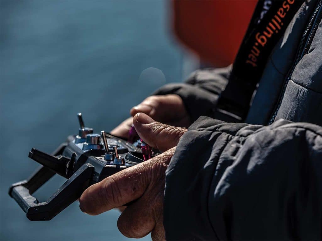 A man holds a remote control in his hands.