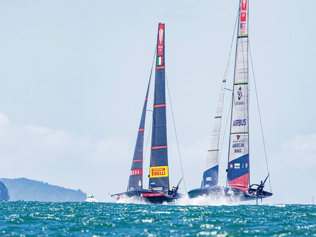 Two sailboats racing across the water.