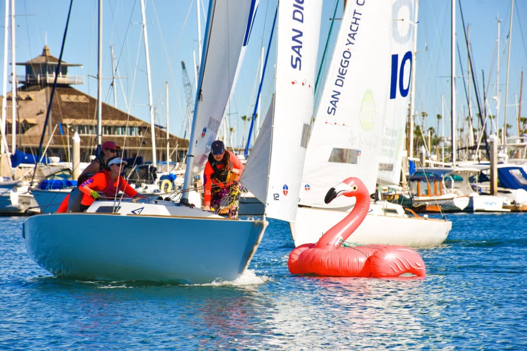 women racing sailboats in front of San Diego Yacht Club