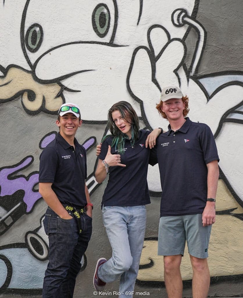 Sailos posing in front of graffiti artwork in Miami's Wynwood District