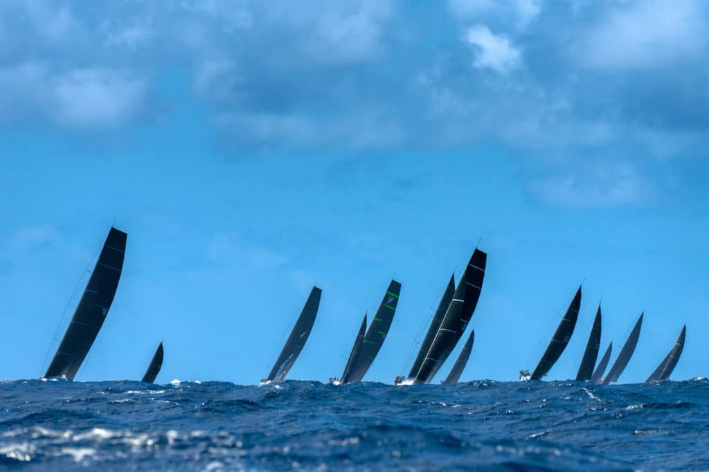 fleet of sailboats racing upwind