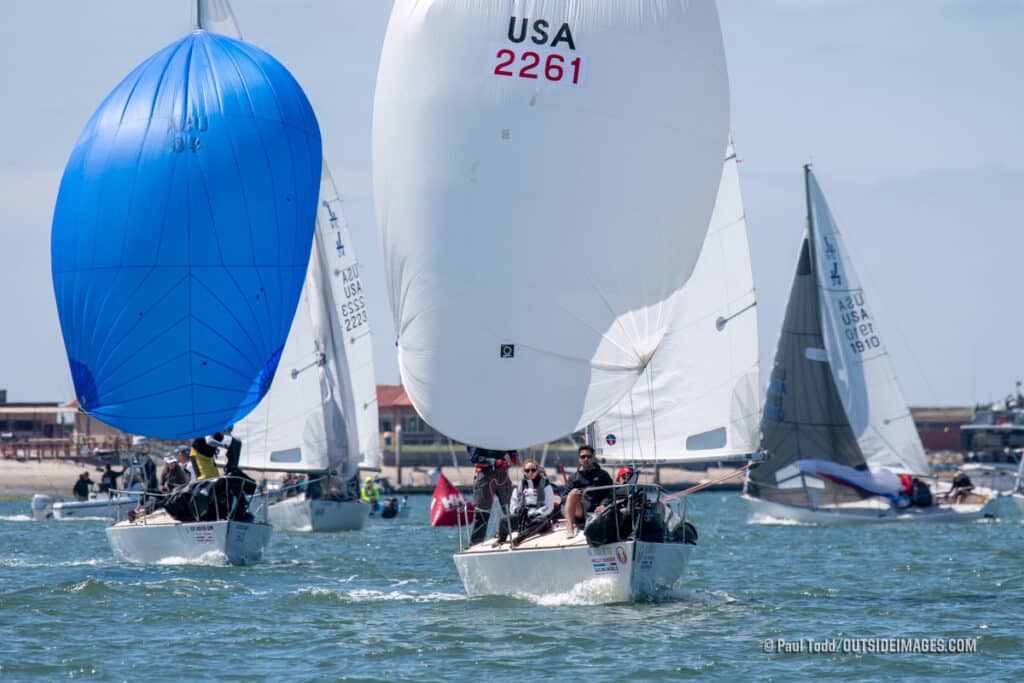 sailors on boats flying spinnakers as they race on San Diego Bay