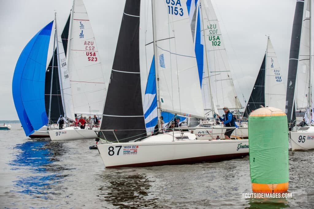 sailboat turning past a buoy in a sailboat race