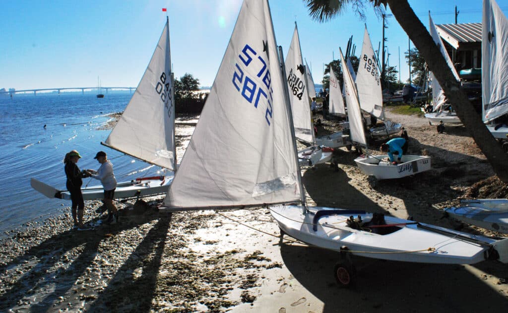 sailors rigging sailboats on the beach on Sarasota Bay, Florida