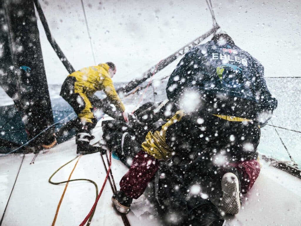 Abby Ehler and skipper Kevin Escoffier during a sail change on deck.