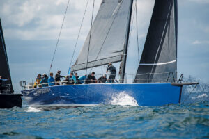 high-tech raceboat with active crew sailing through splashing water at the ORC World Championships in Newport Rhode Island