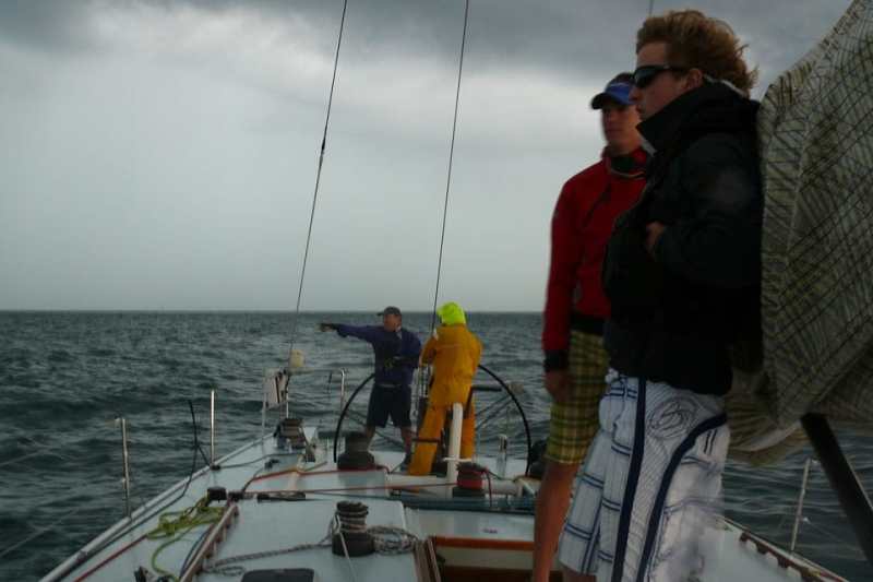 Aboard the Great Lakes 70 Windancer, Drew Shea (foreground) and Thomas Beebe await Friday morning's thunderstorm.