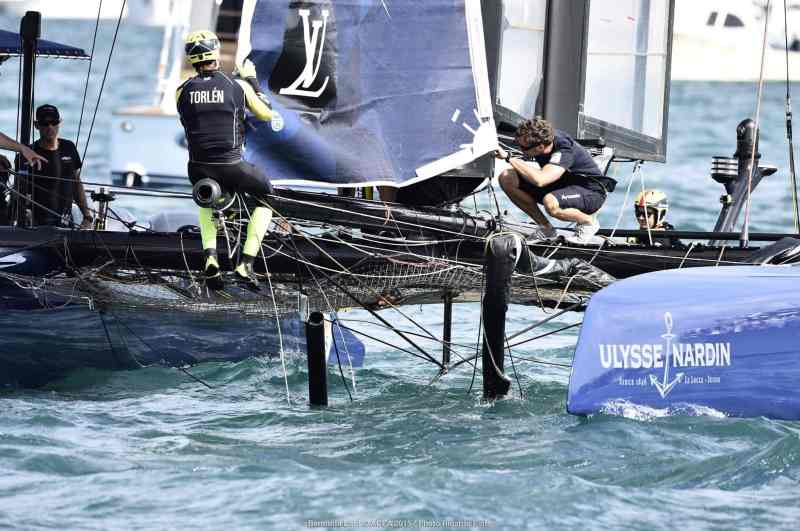 Artemis Racing repairs the damage to their AC 45 after colliding with Shrubb's umpire boat in Bermuda.