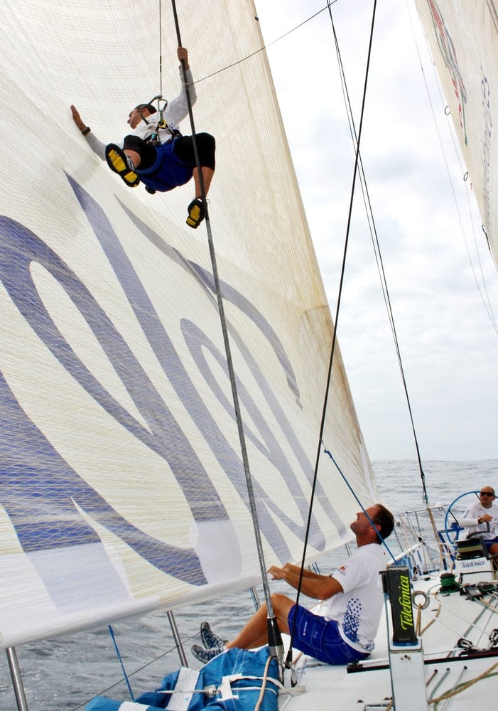 On Telefonica Blue, Pepe Ribes repairing a small hole in the sail.