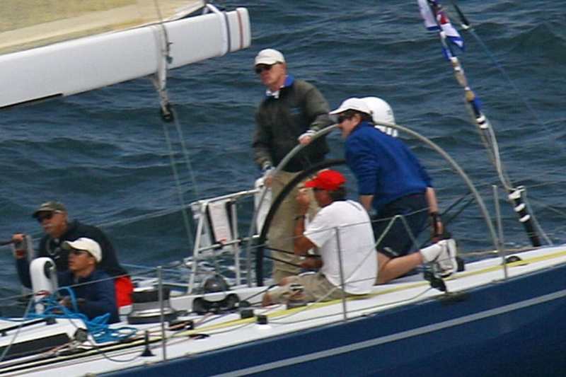 Brack Duker drives Holua, the overall leader; Mark Rudiger at right, Dave Ullman far left.