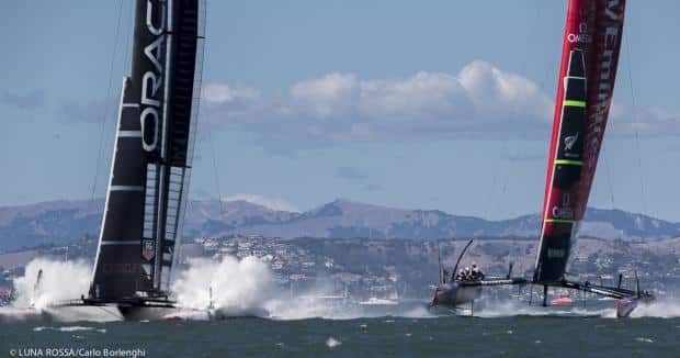 Race 19: A dead-even start for the final race saw the boats side by side going into the hairpin turn at the first mark, with Emirates in the favorable inside position. Barker arced gracefully downwind at nearly 50 mph, while Oracle crashed down off its foils and submerged the entire platform. On Day 1, it would’ve been the end of them, but they jumped right back on the foil (“Nice recovery boys,” said Ainslie casually) and chipped away at New Zealand’s lead. Barker was first to the leeward gate with a marginal lead, but Oracle gained at each crossing upwind, rounding the weather mark with a 500-meter lead. 
Photo: Luna Rossa/Carlo Borlenghi
