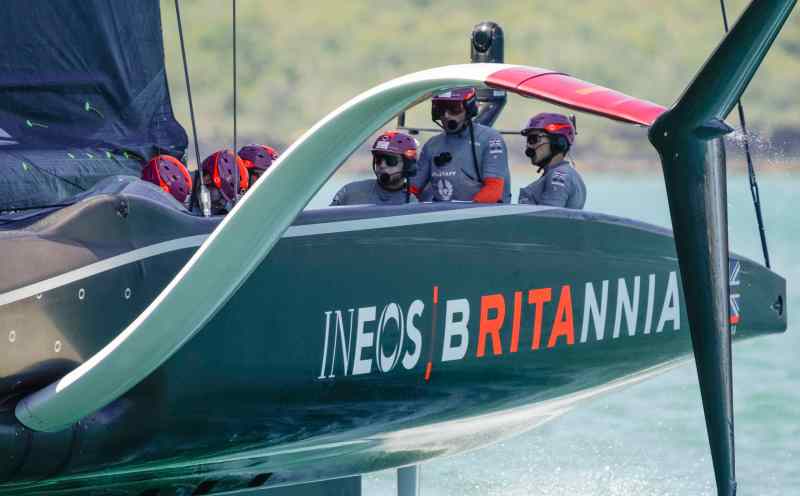 PRADA Cup 2021 – Round Robin 1 A closeup of the British AC75 Britannia, with skipper Ben Ainslie at the helm and visible behind the boat's large foil arm.