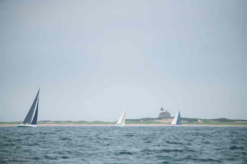boats sailing past Block Island Lighthouse