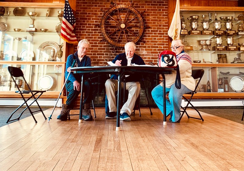 Dr. Charles Shoemaker, Dr. Robin Wallace, and Nancy Parillo convene at Newport YC for the Frostbite season's first hearing.