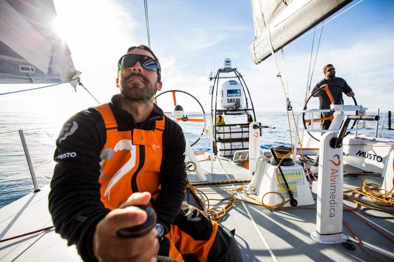 Charlie Enright on the helm and Mark Towill on the winch during the 2014-15 Volvo Ocean Race.