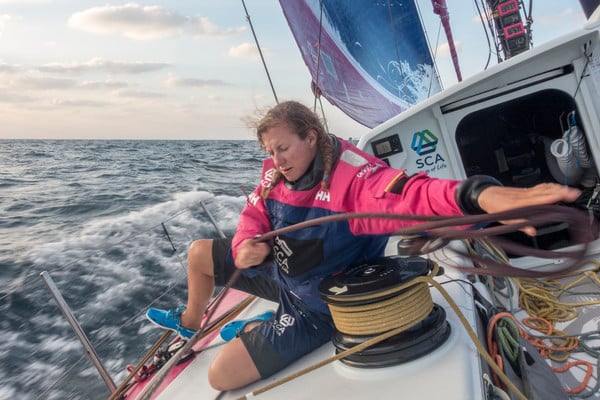 December 10, 2014. Leg 2 onboard Team SCA. Annie Lush pulls a sheet around to leeward.