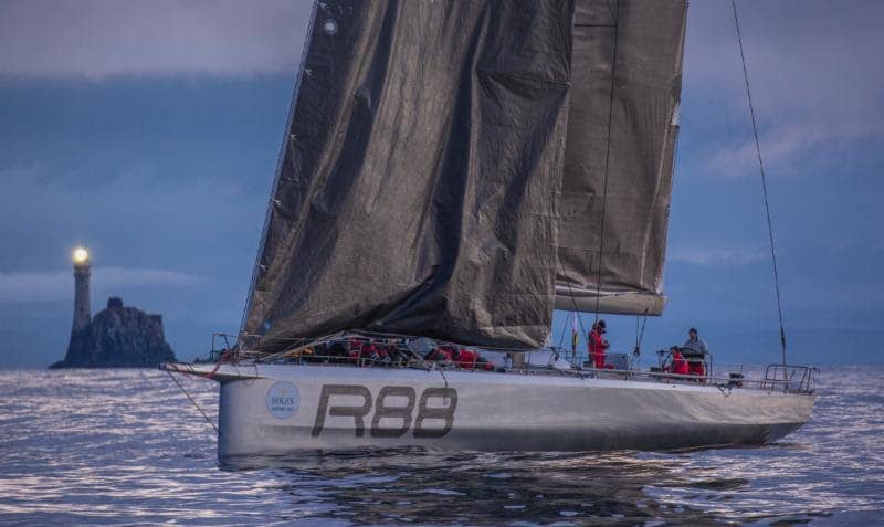 Rambler 88 drifts past the Fastnet Rock