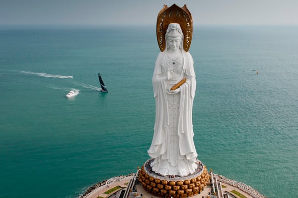 PUMA Ocean Racing powered by BERG, skippered by Ken Read from the USA, sails past the Guan Yin of the South Sea of Sanya, at the start of leg 4 of the Volvo Ocean Race 2011-12, from Sanya, China to Auckland, New Zealand. (Credit: PAUL TODD/Volvo Ocean Race)