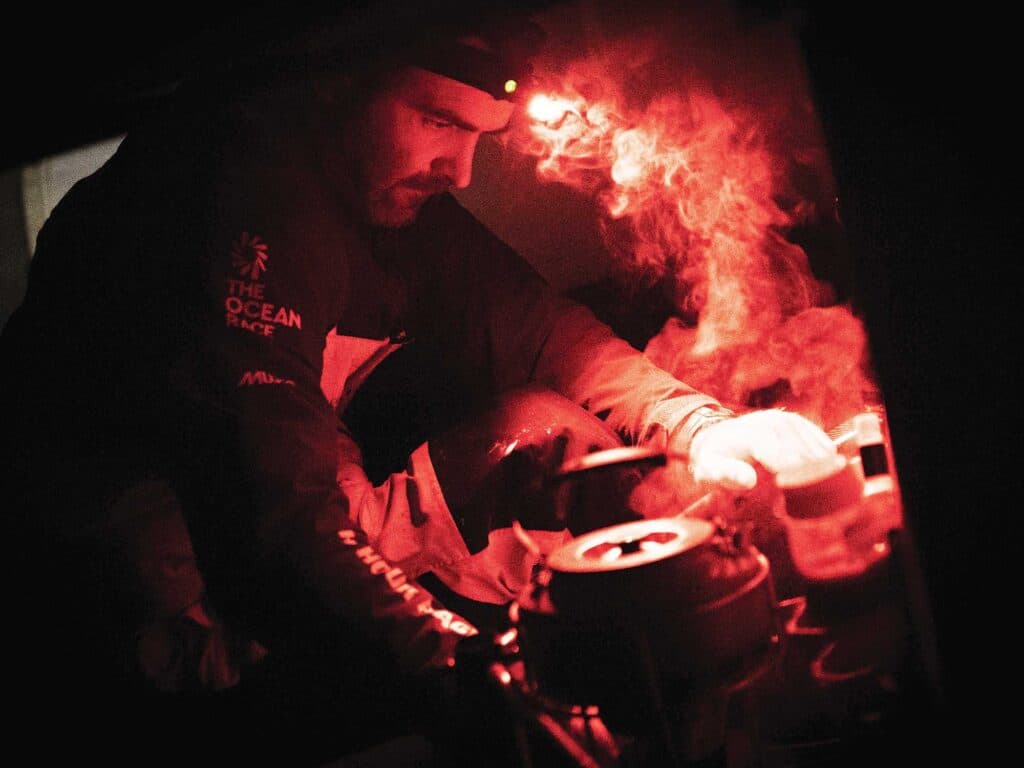 Charlie Enright boils water for dinner in the galley.