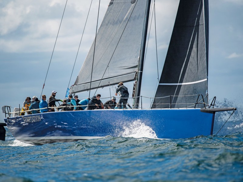 teamwork high-tech raceboat with active crew sailing through splashing water at the ORC World Championships in Newport Rhode Island