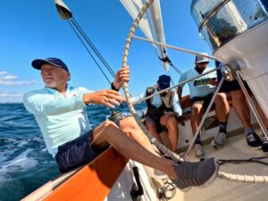 12 Metre skipper Steve Eddleston drives his 12 Meter Weatherly from the leeward wheel of the yacht.