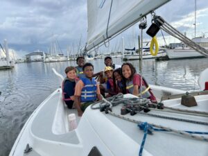 Kids from the New Orleans Community Sailing Center on a sailboat at the dock.