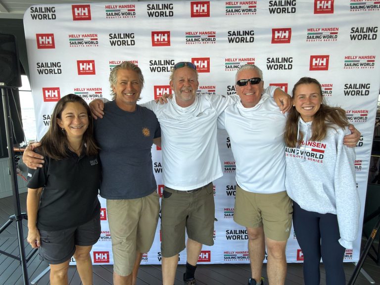 IMG_3091 The 2026 Helly Hansen Sailing World Regatta event team (l to r): Priscilla Scollin, Dave Reed, Paul Todd, Walter Cooper and Carly Starck pause for a snap on the porch of Marblehead’s Corinthian YC.